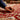 A person hand knotting a rug